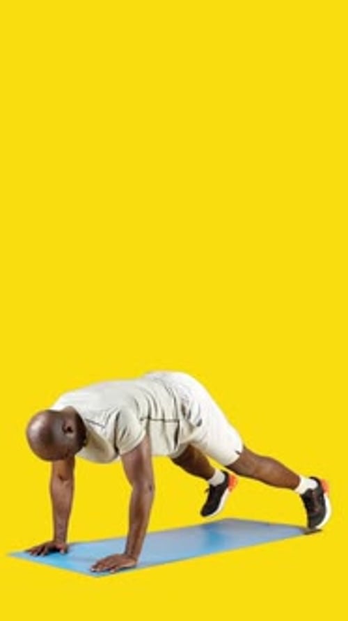 Man Performs Mountain Climber Exercise on Yoga Mat