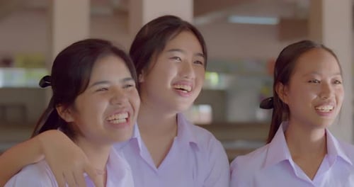 Cena em câmera lenta: Um grupo de meninas estudantes asiáticas felizes, sorridentes e risonhas do ensino médio