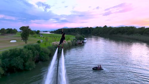 Aerial View Fearless Woman Flyboarding Into Evening