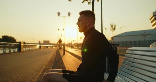 Young Athlete Doing Reverse Pushups From a Bench on a City Street at Sunset
