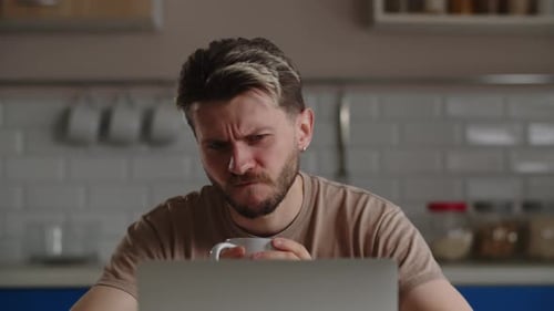 Man Working at Computer From Home with Coffee