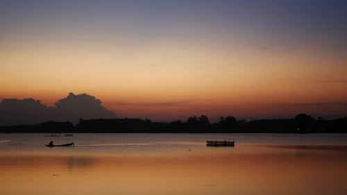 Sunset Lake Scene with Silhouette Fisherman