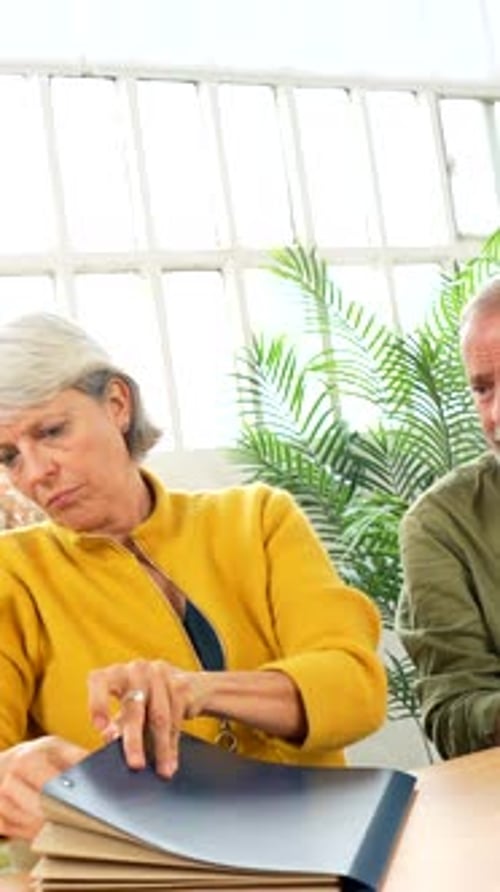 Mature Couple Reviewing Important Documents at Table
