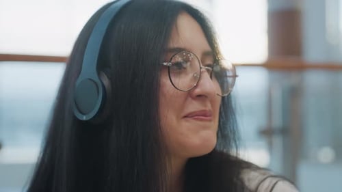 Close Up of Happy Woman Dancing with Headphones and Smiling in Indoor Mall Scene