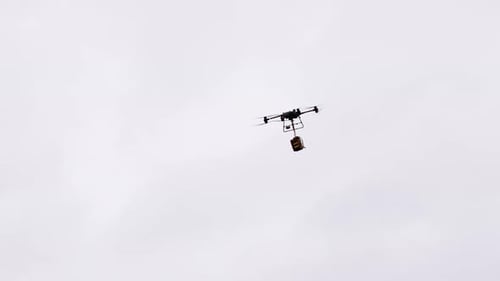 Industrial delivery drone transport heavy medical emergency bag in bright sky