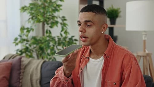 Young Man Using Voice Commands on Mobile Phone