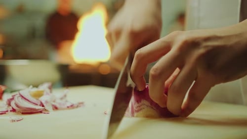 Chef Chopping Red Onion in Commercial Kitchen