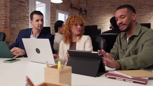 Diverse Team Collaborating with Tech in Modern Office