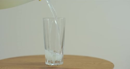 Pouring Water Into a Glass Slow Motion Bubbles Rise Up