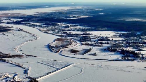Aerial panoramic drone shot captures a serene winter story of a quiet village nestled between