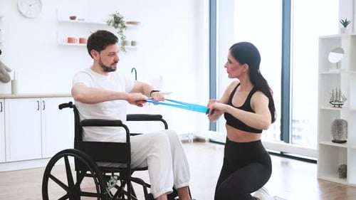 Man in Wheelchair Working Out With Resistance Band