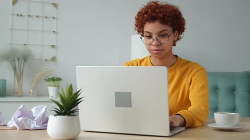 African American Girl Using Laptop at Home Office Looking at Screen Typing Chatting Reading Writing