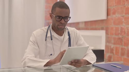 Doctor Using Tablet in Office