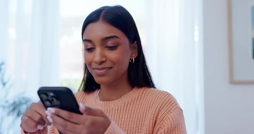 Young Woman Using Smartphone in Bright Home