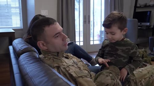 Soldier home with family and child playing