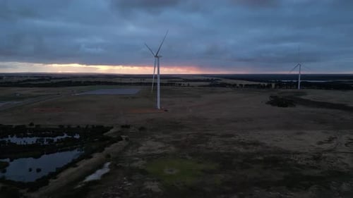 Wind turbines spinning at dusk, Esperance area in Western Australia. Aerial drone view