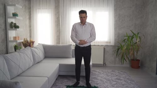 Man Kneeling and Praying Indoors