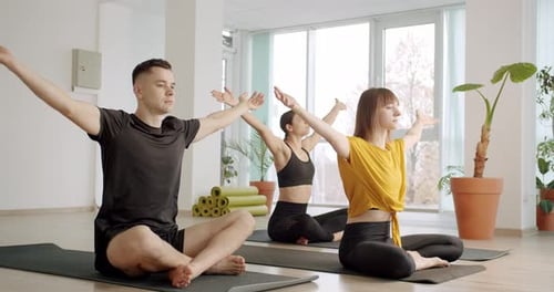 Young People Meditating in Studio Together