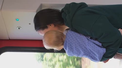 Mother and Baby on Train Looking out Window