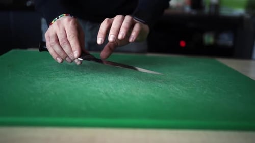 Man sharpens a knife. sharpening a chef's knife