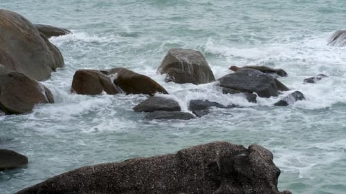 Danger Sea Wave Crashing on Rock Coast with Spray and Foam
