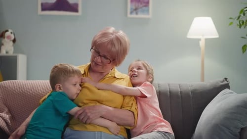 Grandmother Receiving Affectionate Hugs From Grandchildren at Home