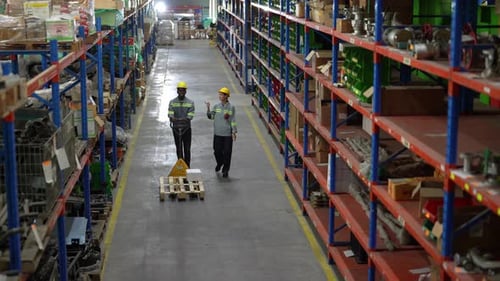 Warehouse Industrial and Logistics Companies. Dispatcher in uniform making inventory in storehouse.