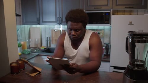 Man Uses Tablet with Fruits and Vegetables