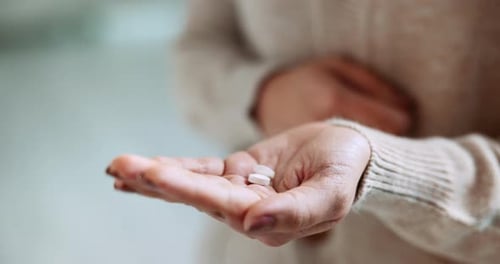 Adult Dispensing White Pills into Hand