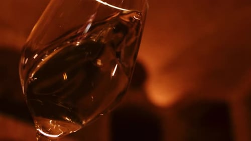 Close-up of Swirling White Wine in Glass