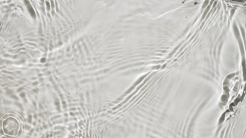 Pure Water with Reflections Sunlight in Slow Motion Water Surface Texture Top View Sun and Shadows