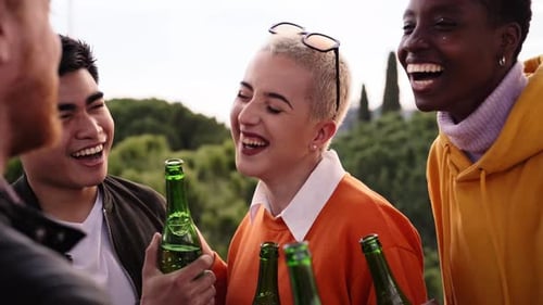 Group of Friends Laughing Together with Green Bottles