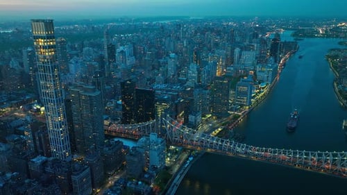 Beautiful evening cityscape of New York in lights. Drone footage over the river