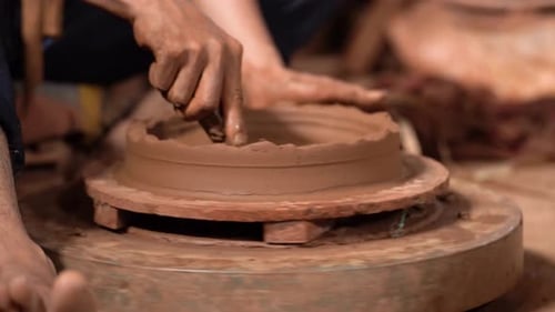 Hands Shaping Clay on Spinning Pottery Wheel