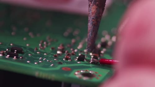 Macro Close Up of a Man is Repairing a Chip with a Soldering Iron