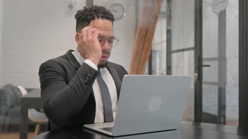 Man Working on Laptop in Office