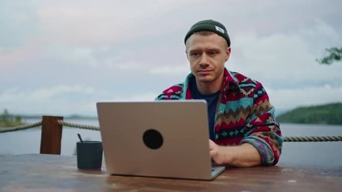 Young Adult Working on Laptop Outdoors in Nature