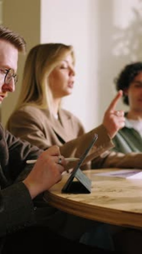 Coworkers in Modern Office Discussing Business Data