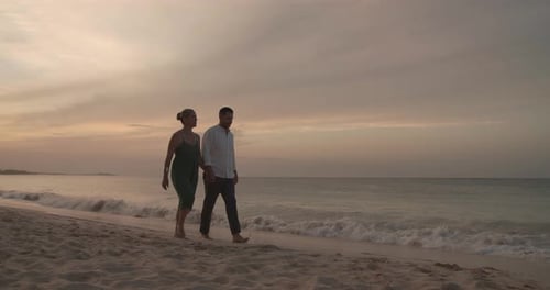 Romantic sunset walk on a tropical beach paradise for a loving couple in the caribbean