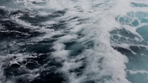 Dynamic Closeup of Ocean Wake with Foamy White Water and Turquoise Swirls Capturing the Turbulent