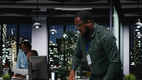 African American Advisor Focusing on a Complex Problem in a Dark Office