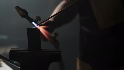 Sparks fly as metal is welded in a blacksmith's workshop
