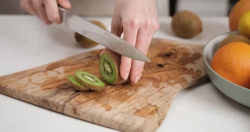 Slicing Fresh Kiwi Fruit with Knife