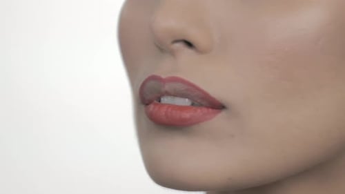 Woman Applying Red Lipstick with Brush, Close Up