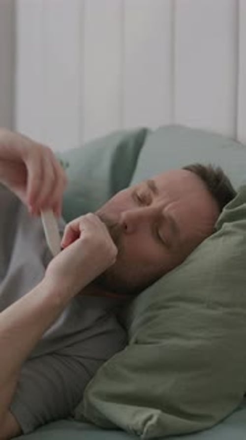 Adult Man Lying on Couch Feeling Sick