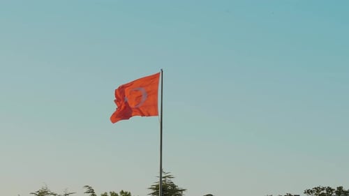 Red Flag Waving in Blue Sky