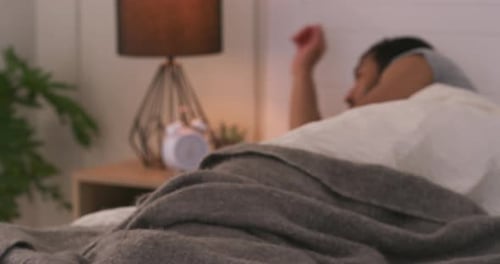 Man sleeping in his bed in the bedroom