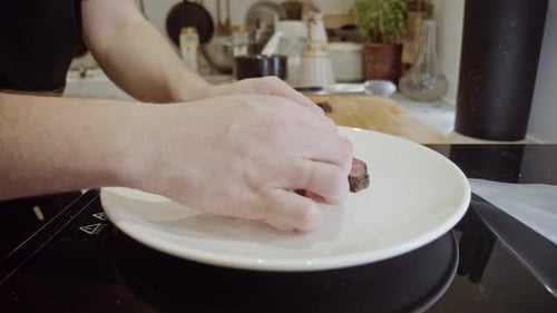 Arranging Slices of Medium Rare Beef on Plate