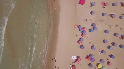 Summertime in a public Beach with colorful umbrellas