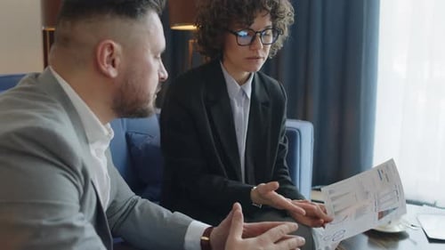 Business Colleagues Discussing Company Indicators on Chart